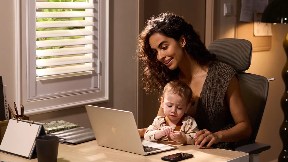 Mom with baby using wearable breast pump
